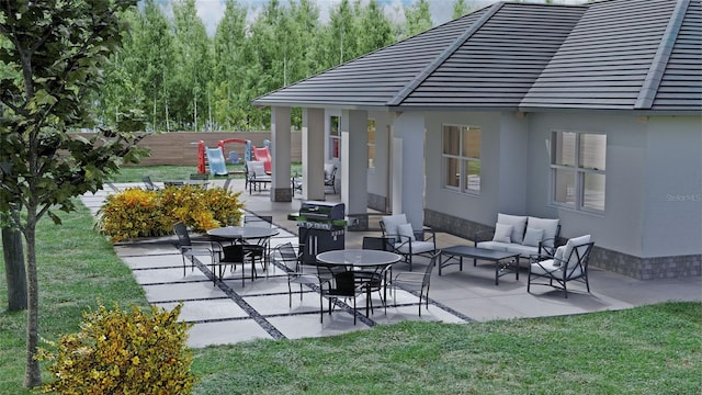 view of patio with area for grilling, fence, and an outdoor living space