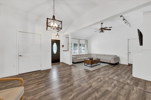 unfurnished living room with dark wood-type flooring, lofted ceiling, baseboards, and ceiling fan with notable chandelier