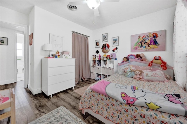 bedroom featuring ceiling fan, wood finished floors, and visible vents