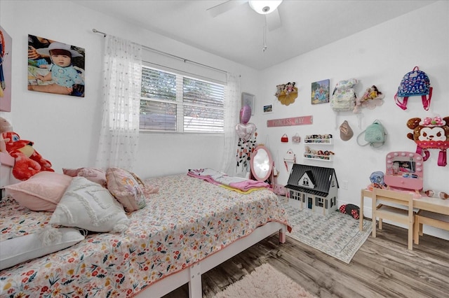 bedroom with a ceiling fan and wood finished floors