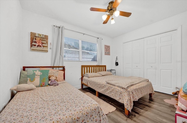 bedroom with a ceiling fan, a closet, and wood finished floors