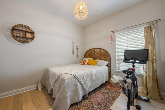 bedroom with light wood-style flooring and baseboards