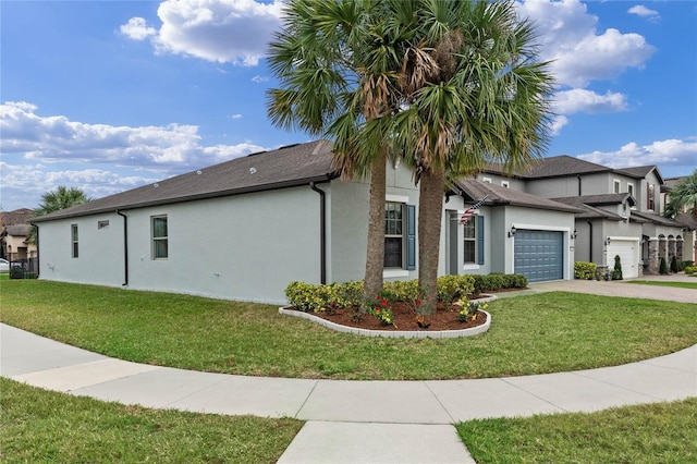 view of home's exterior with a lawn, driveway, an attached garage, and stucco siding