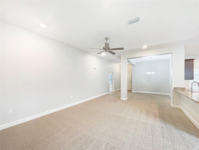 interior space with recessed lighting, ceiling fan with notable chandelier, visible vents, baseboards, and carpet