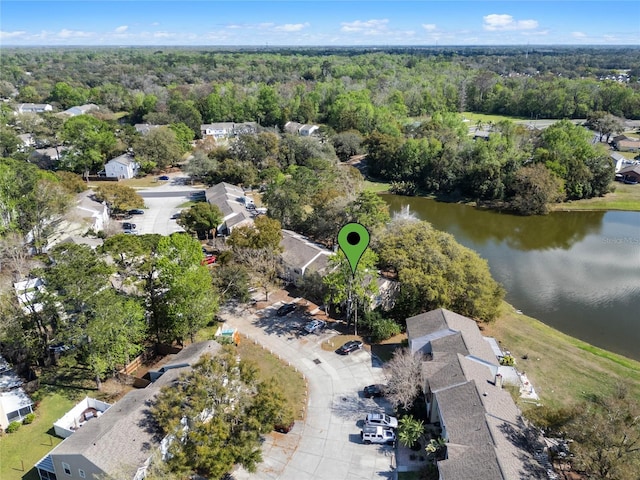 birds eye view of property featuring a water view and a view of trees