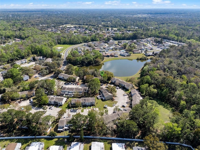 birds eye view of property with a forest view and a water view