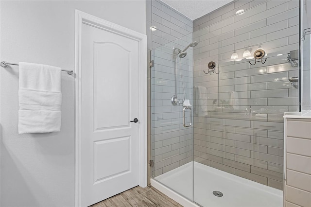 full bath featuring a shower stall and wood finished floors