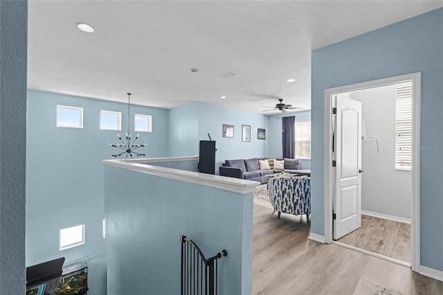 kitchen featuring recessed lighting, visible vents, a textured ceiling, wood finished floors, and baseboards