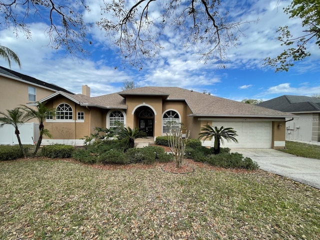 ranch-style home with stucco siding, concrete driveway, a shingled roof, a garage, and a chimney