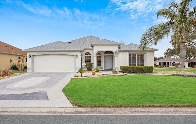 view of front facade featuring a garage, a front yard, concrete driveway, and stucco siding