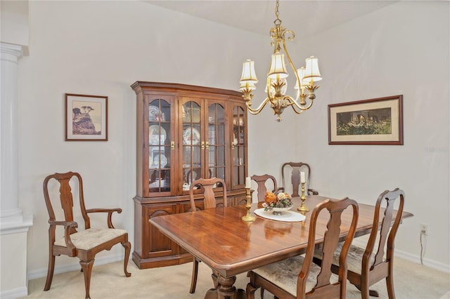 dining area with baseboards, light carpet, ornate columns, and an inviting chandelier