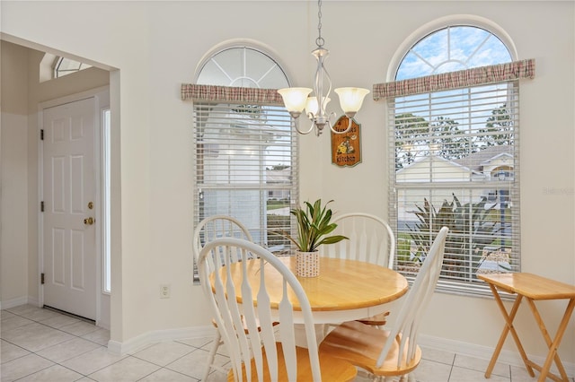 dining space with a notable chandelier, baseboards, and light tile patterned floors