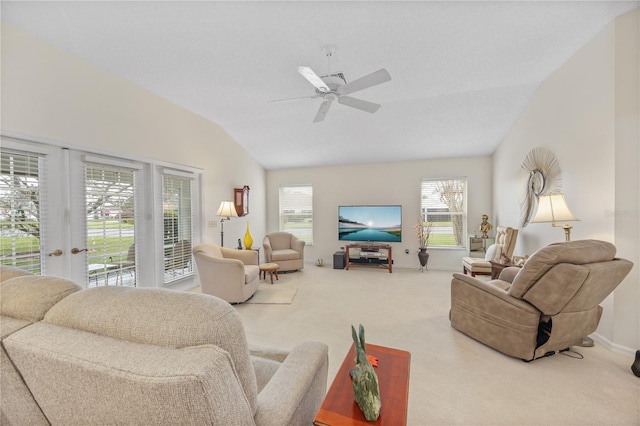 living room featuring a wealth of natural light, carpet, vaulted ceiling, and a ceiling fan