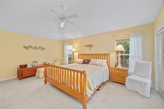 bedroom with carpet flooring, vaulted ceiling, a textured ceiling, ceiling fan, and baseboards