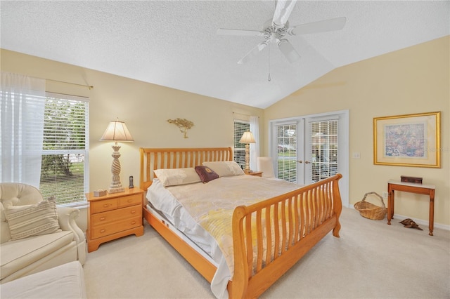 bedroom with a textured ceiling, lofted ceiling, light carpet, access to outside, and french doors