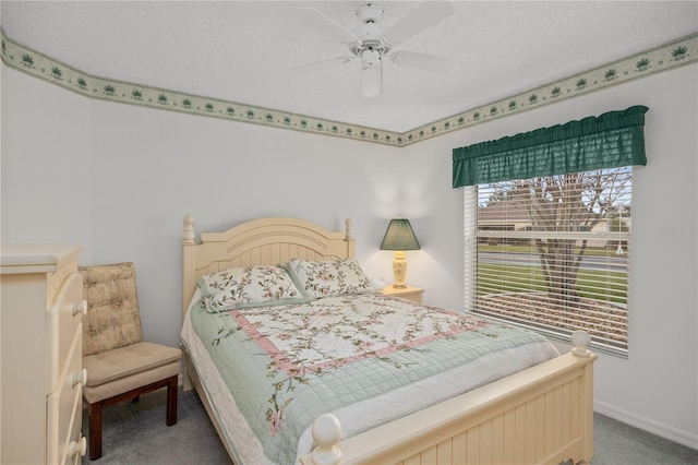 carpeted bedroom featuring a textured ceiling, ceiling fan, and baseboards