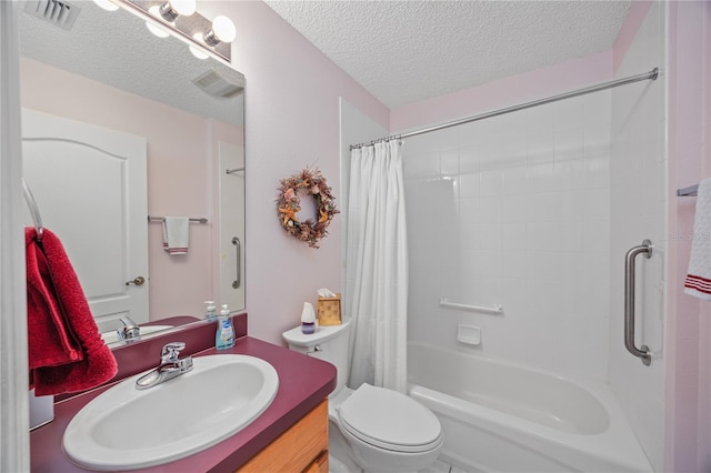 full bathroom featuring toilet, visible vents, a textured ceiling, and vanity