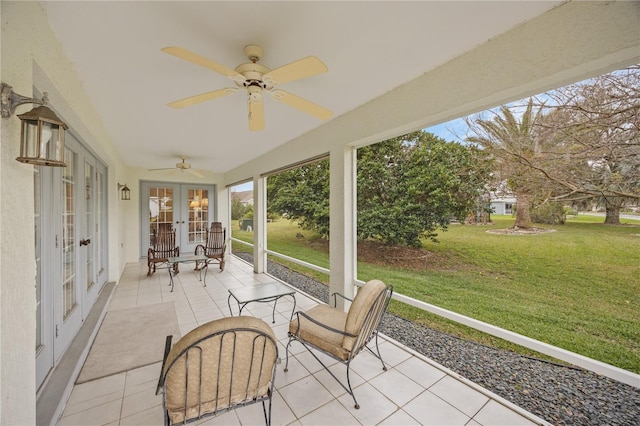 unfurnished sunroom with ceiling fan and french doors