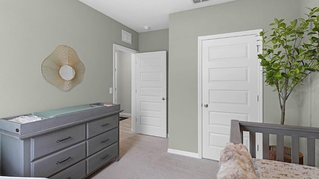 bedroom featuring light carpet, visible vents, and baseboards