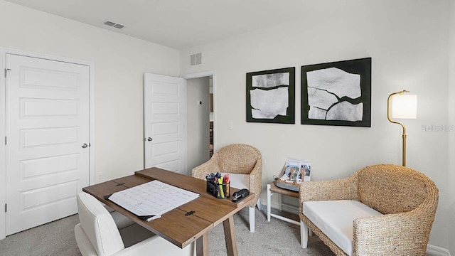 office area featuring visible vents and carpet flooring