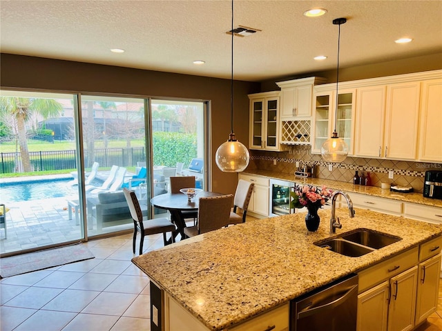 kitchen featuring beverage cooler, a sink, backsplash, and dishwasher