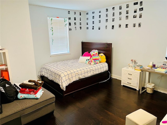 bedroom featuring wood finished floors and baseboards