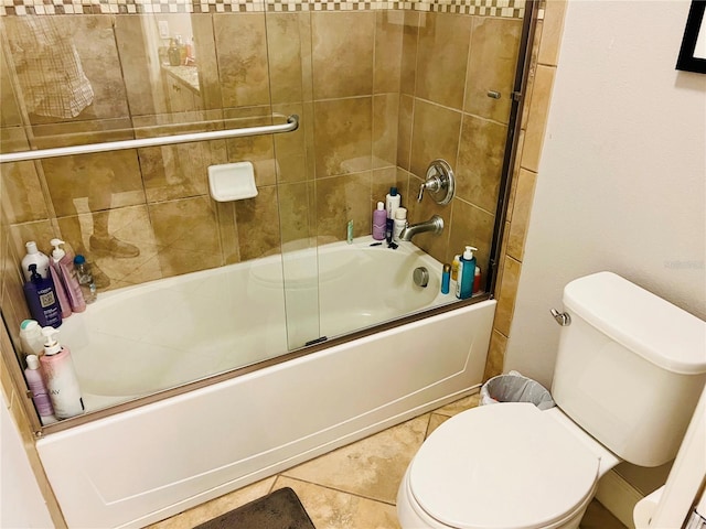 full bathroom with toilet, shower / bath combination with glass door, and tile patterned flooring