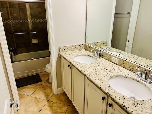 bathroom with toilet, tile patterned flooring, and a sink