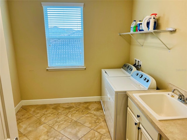 laundry room with washer and clothes dryer, light tile patterned floors, cabinet space, a sink, and baseboards