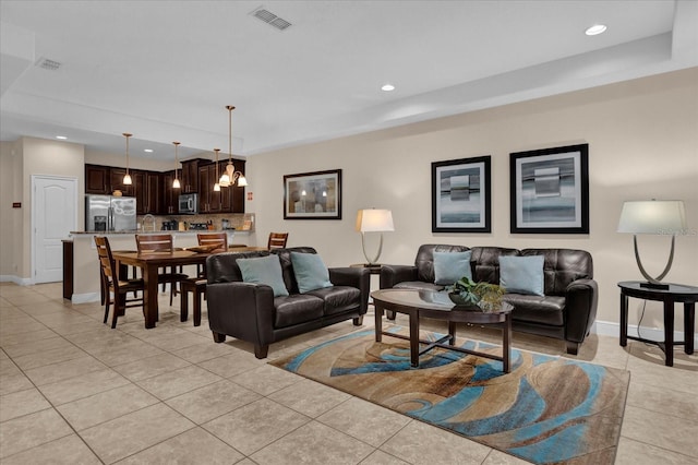 living area featuring light tile patterned floors, visible vents, and recessed lighting