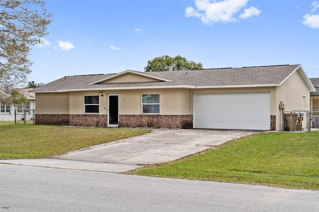 single story home featuring a garage, driveway, fence, a front lawn, and stucco siding