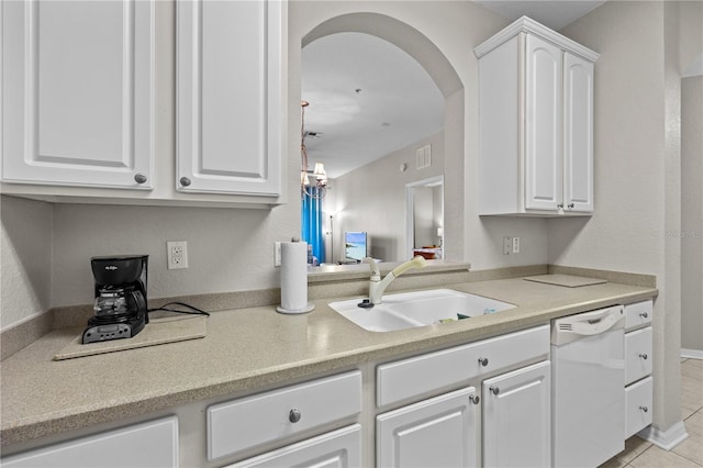 1357 Venezia Ct Unit 402, Davenport, FL 33896 - kitchen with arched walkways, light countertops, white cabinets, a sink, and dishwasher