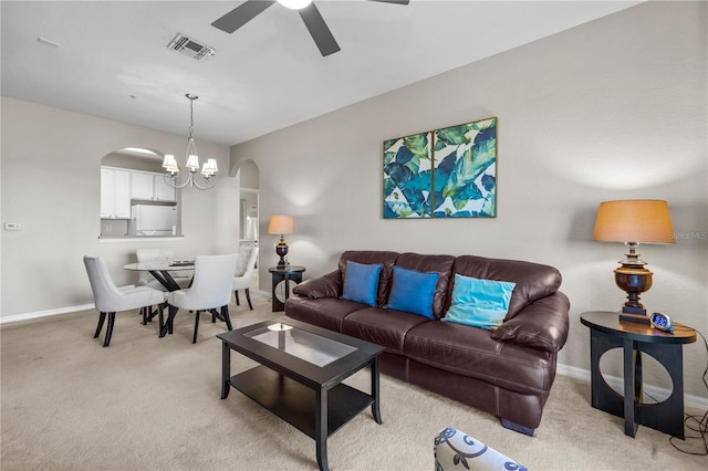 1357 Venezia Ct Unit 402, Davenport, FL 33896 - living room featuring arched walkways, ceiling fan with notable chandelier, visible vents, and light colored carpet