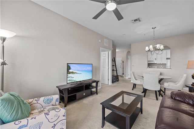 1357 Venezia Ct Unit 402, Davenport, FL 33896 - living area featuring arched walkways, visible vents, light carpet, and ceiling fan with notable chandelier