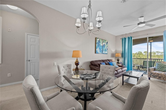 1357 Venezia Ct Unit 402, Davenport, FL 33896 - dining space featuring arched walkways, ceiling fan with notable chandelier, light carpet, and baseboards