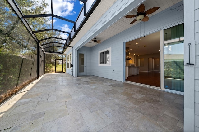 view of patio / terrace featuring glass enclosure and ceiling fan