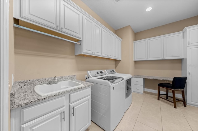 clothes washing area featuring light tile patterned flooring, recessed lighting, a sink, cabinet space, and washer and clothes dryer