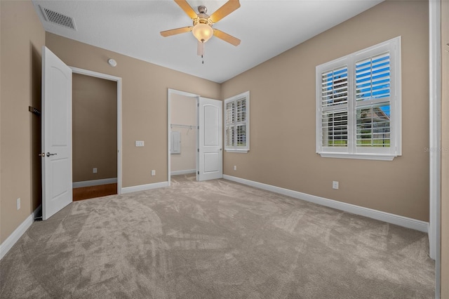 unfurnished bedroom with carpet floors, visible vents, and baseboards