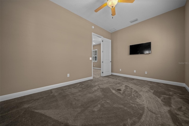 carpeted spare room with lofted ceiling, baseboards, visible vents, and a ceiling fan