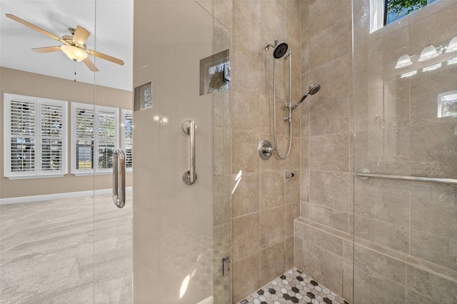 full bath featuring a ceiling fan, a shower stall, and baseboards