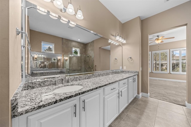 bathroom featuring a wealth of natural light, a sink, and a tile shower