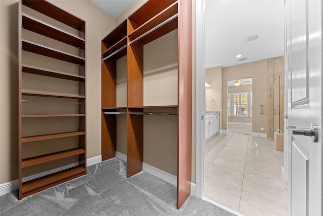 spacious closet featuring light tile patterned flooring and visible vents