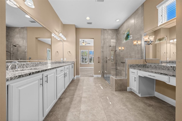 full bathroom featuring a stall shower, baseboards, visible vents, and vanity