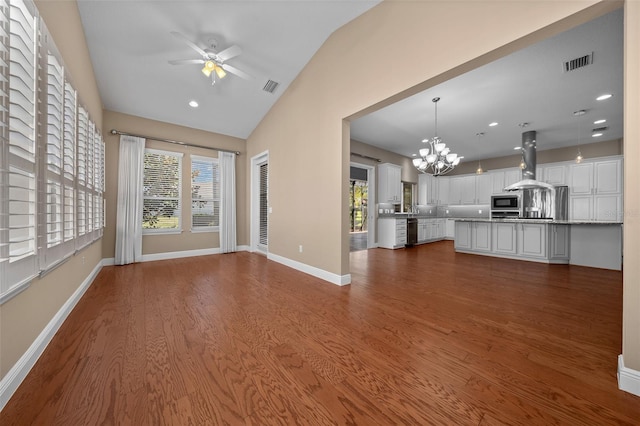 unfurnished living room featuring plenty of natural light, dark wood finished floors, and visible vents