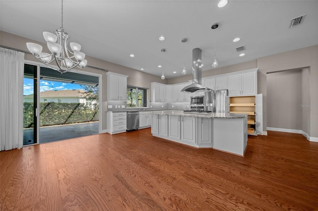 kitchen with white cabinetry, visible vents, island range hood, and stainless steel appliances