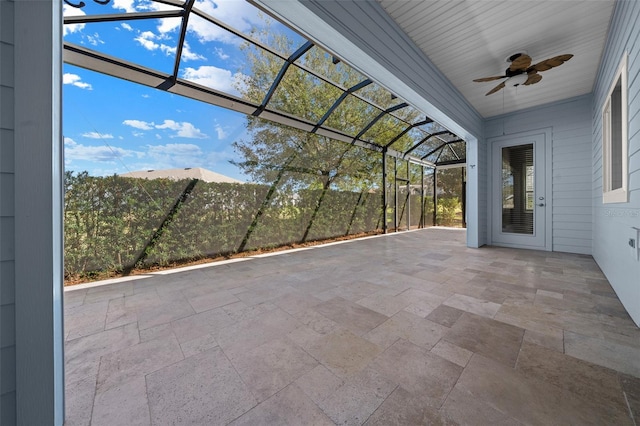 view of patio / terrace with a ceiling fan and glass enclosure