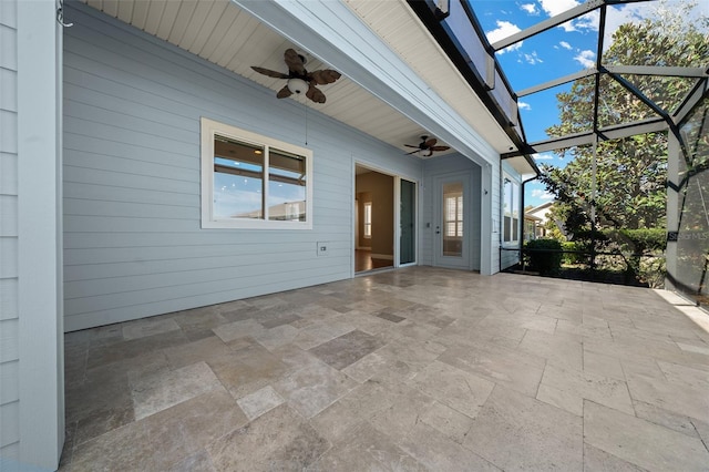 unfurnished sunroom with plenty of natural light and ceiling fan