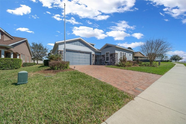 view of front facade with a garage, stone siding, decorative driveway, a front lawn, and board and batten siding