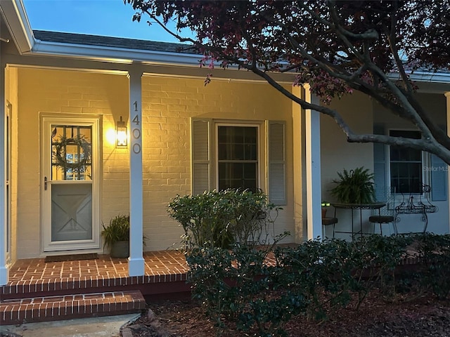 property entrance with brick siding