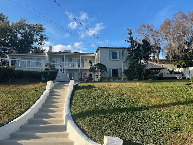 view of front of property with a front yard and stairway